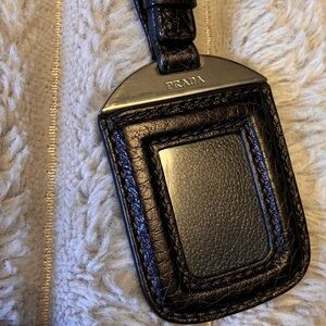 Authentic Prada luggage tag black pebble leather silver hardware gently used.